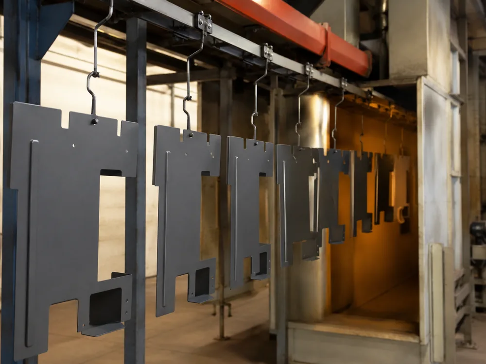 Powder coated sheet metal parts on a curing line